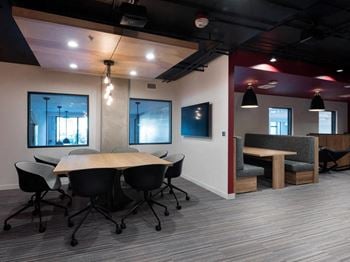 A conference room with a long table and chairs.